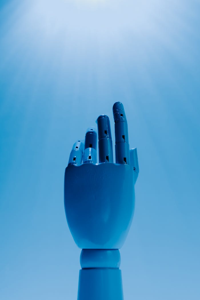 A robotic hand reaching out against a radiant blue sky, symbolizing futuristic technology.